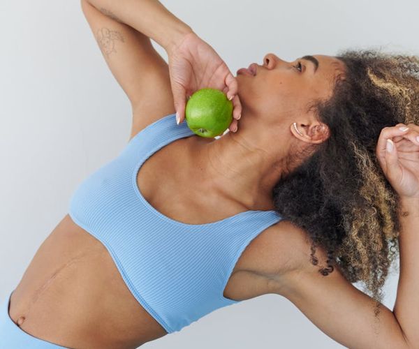 Woman performing a dynamic yoga stretch, embodying energy and vitality.